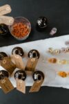 A collection of essential oils and natural ingredients on a marble surface for aromatherapy.