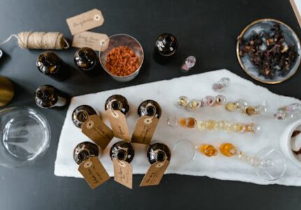 A collection of essential oils and natural ingredients on a marble surface for aromatherapy.
